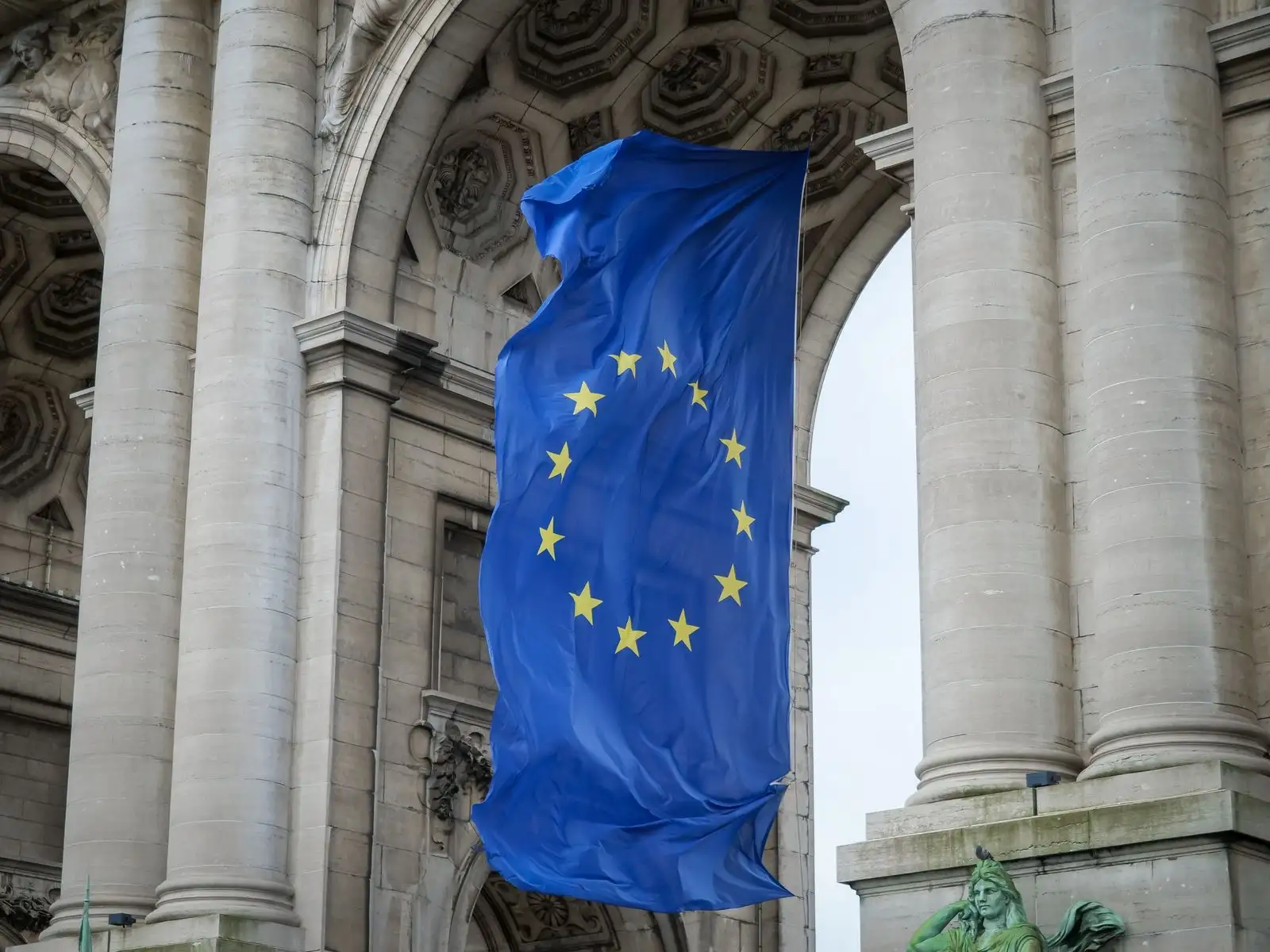 European Union flag flying under the Cinquantenaire arches in Brussels