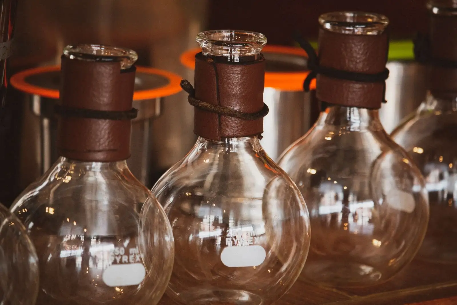 Laboratory round-bottom flasks sitting in heating mantles, the equipment of a chemical synthesis