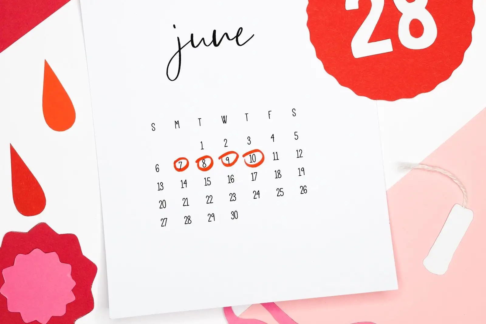 Paper calendar for June, with four days circled in red to track a period
