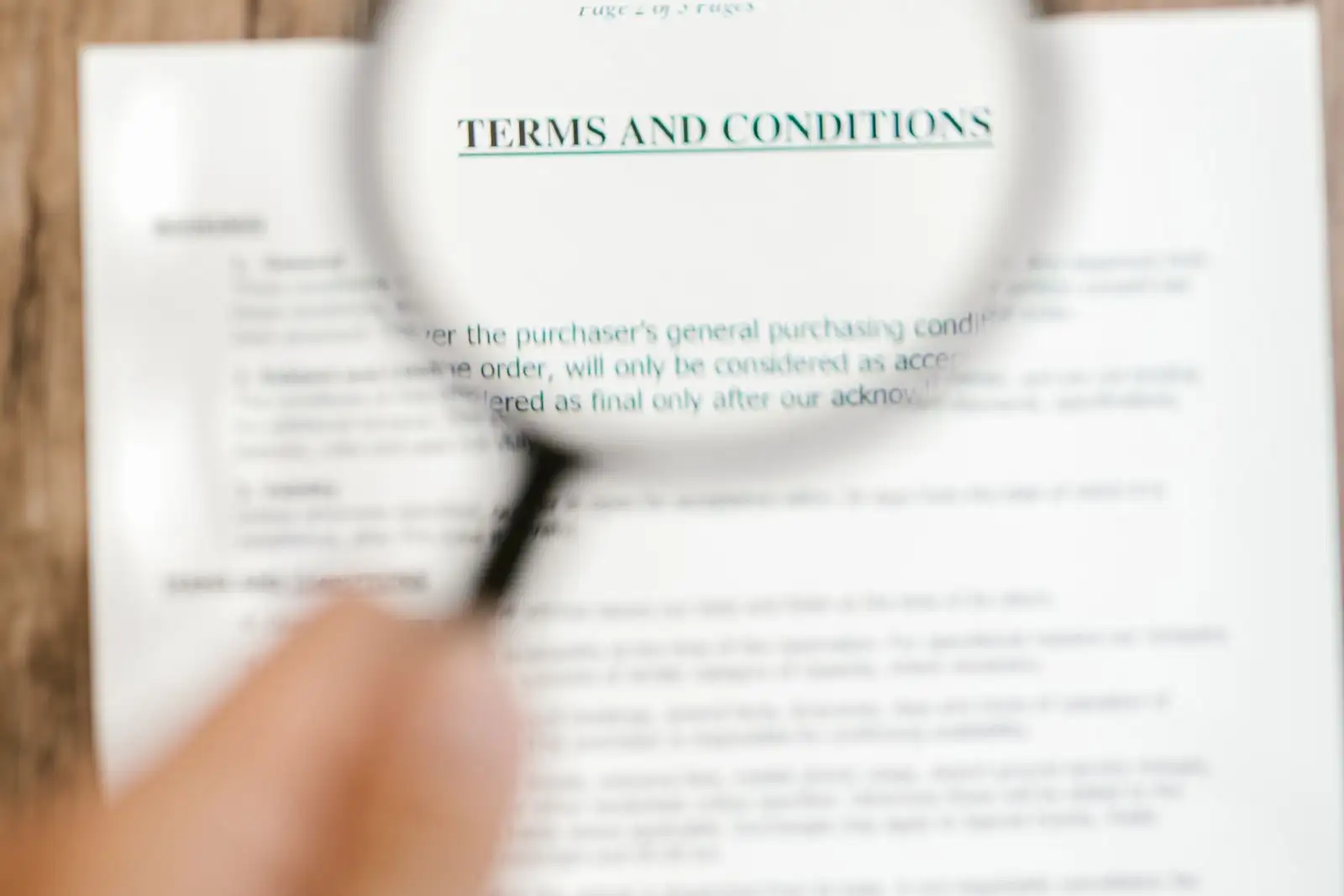 A magnifying glass held over a printed document to read the small print