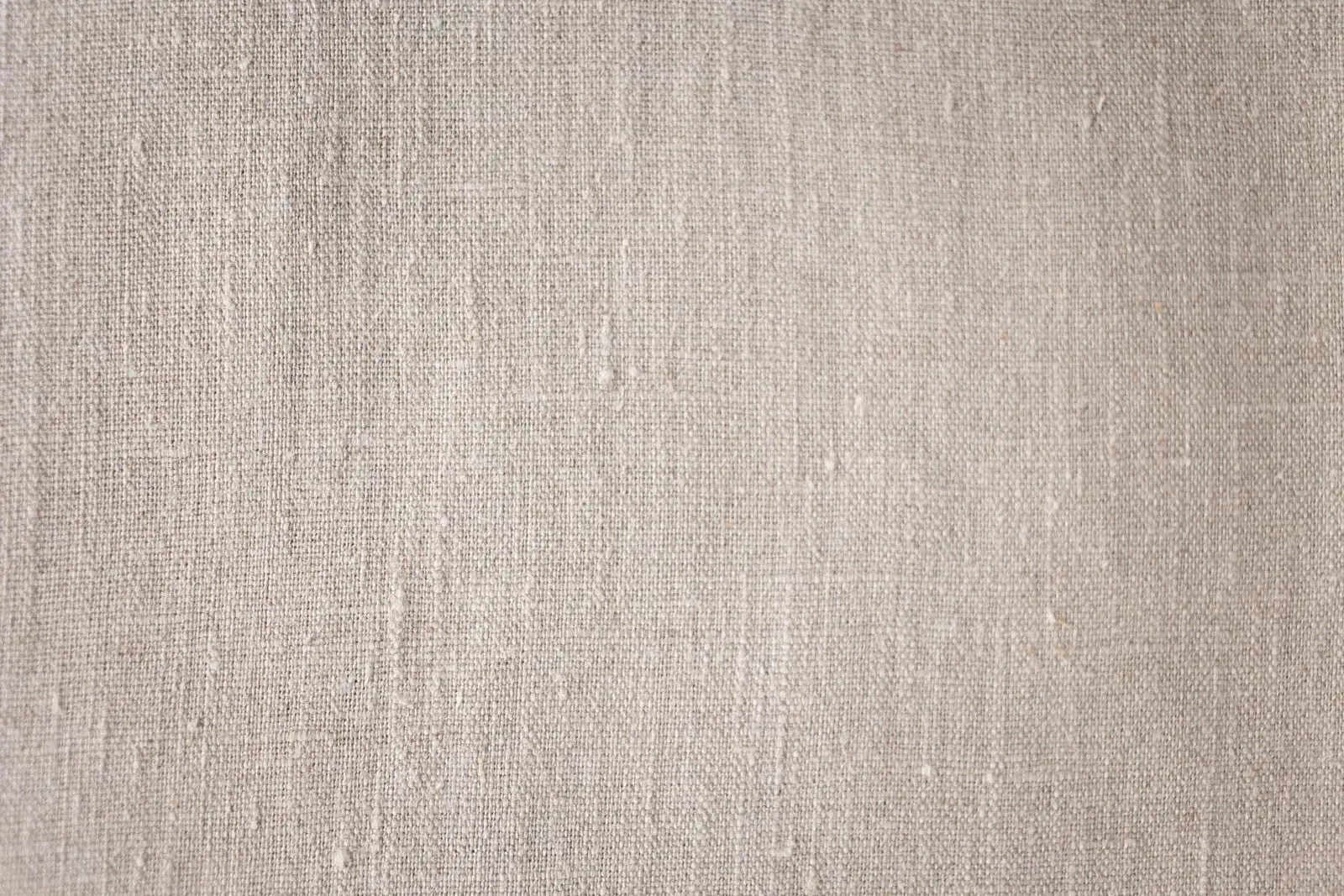 Close-up of an undyed plant-fibre fabric: by eye, nothing tells hemp apart from linen