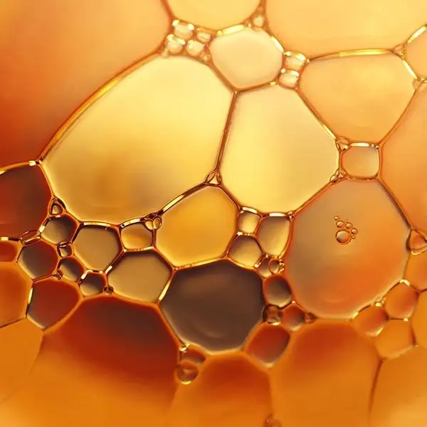 Macro close-up of golden oil droplets