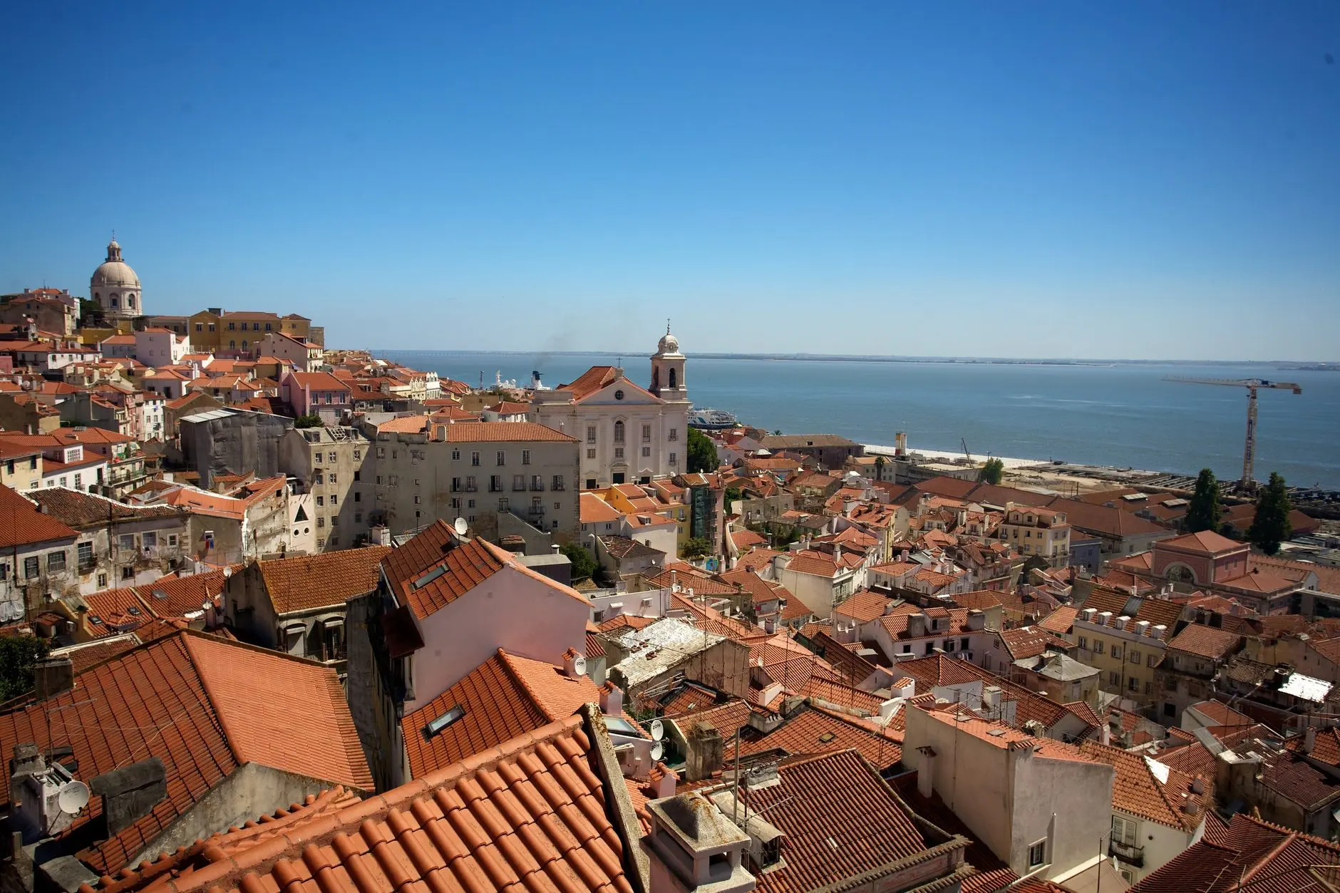 Lisbon rooftops sloping down towards the Tagus.