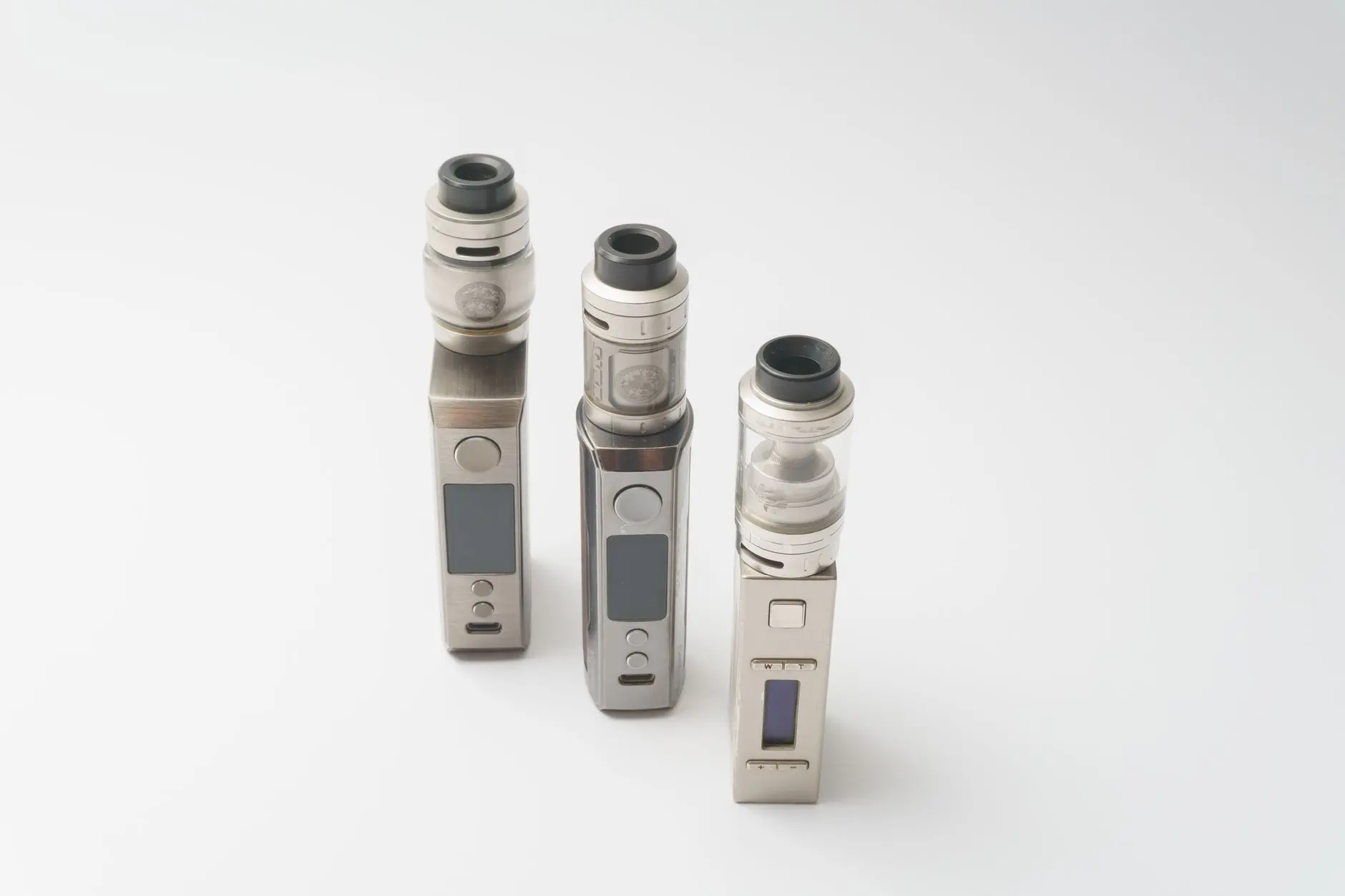Three refillable tank vaping devices on a white background, the format that remains allowed